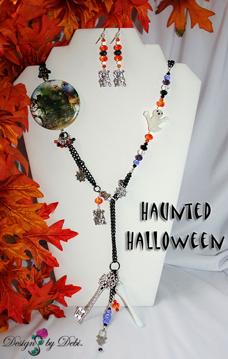 Designs by Debi Handmade Jewelry for Charity Set October 2012 to benefit Born This Way Foundation. A one of a kind Halloween theme lariat necklace and earrings made with Swarovksi and other crystals in black, black diamond, fire opal and purple velvet, a unique Haunted House focal piece, black curb chain, a white glass ghost, haunted house, spider web and padlock charms, a white glass bone pendant bead and a large silver skeleton key. Copyright Designs by Debi.