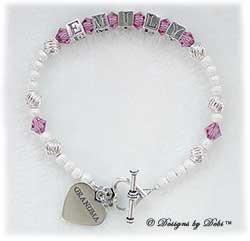 Designs by Debi Handmade Jewelry Keepsake Bracelet in the Karen Style Twist and Stardust bead combination with Rose (October) crystals, a heart toggle clasp and Grandma heart charm. Grandmother's or Nana's Bracelet