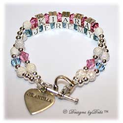 Designs by Debi Handmade Jewelry 2 strand Keepsake Bracelet in the Karen Style Stardust and Seamless Round bead combination with Rose (October) and Aquamarine (March) crystals, a heart toggle clasp and Grandma heart charm.  Grandmother's or Nana's Bracelet