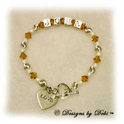 Designs by Debi Handmade Jewelry Personalized Keepsake Bracelet Wife's Bracelet, Keepsake Bracelet in the Melania Style Twist and Stardust bead combination with Topaz (November) crystals, a heart toggle and Love heart charm. Wife's Bracelet