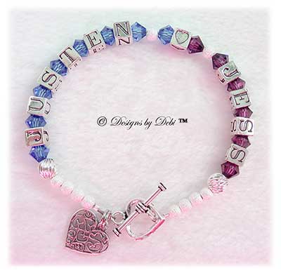 Designs by Debi Handmade Jewelry Karen Style Couples Keepsake Bracelet in the Twist and Stardust bead combination with Sapphire (September) and Amethyst (February) crystals, a heart toggle clasp and Filigree Hearts in Heart charm.